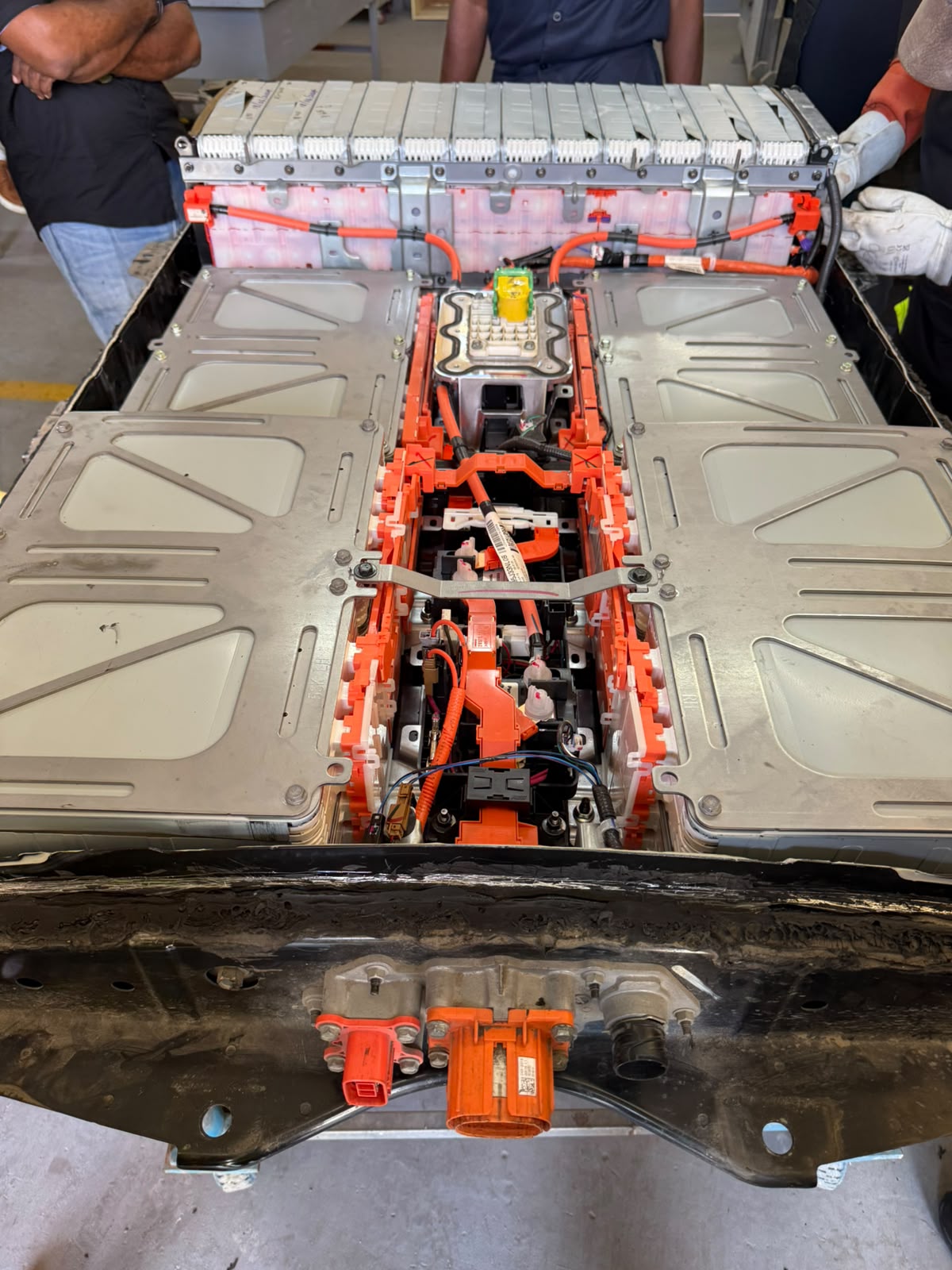 Detailed view of the orange electrical connections and modules during EV training