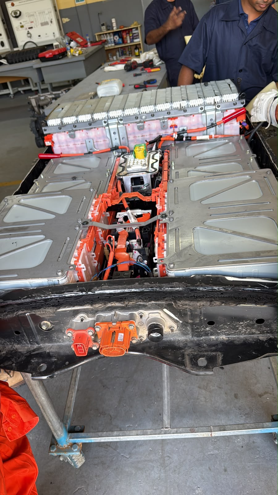 Opened EV training system showing modules and orange high-voltage connections